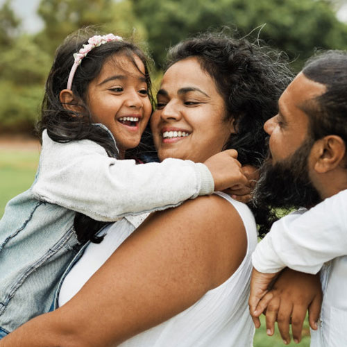 happy family holding daughter in the park