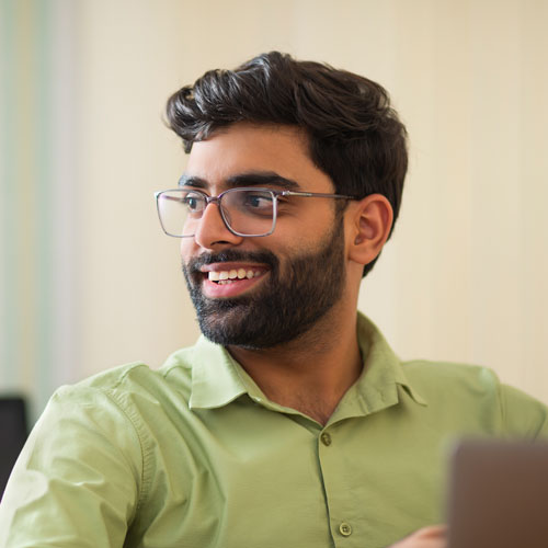 smiling man in green shirt