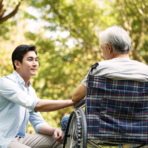 young man with older man in wheelchair
