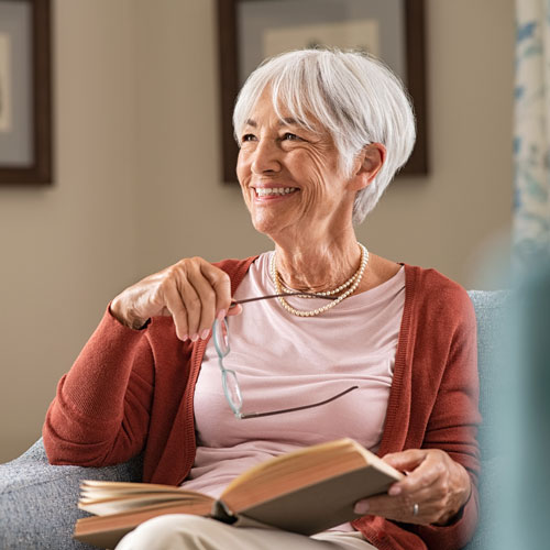 smiling older woman holding a book