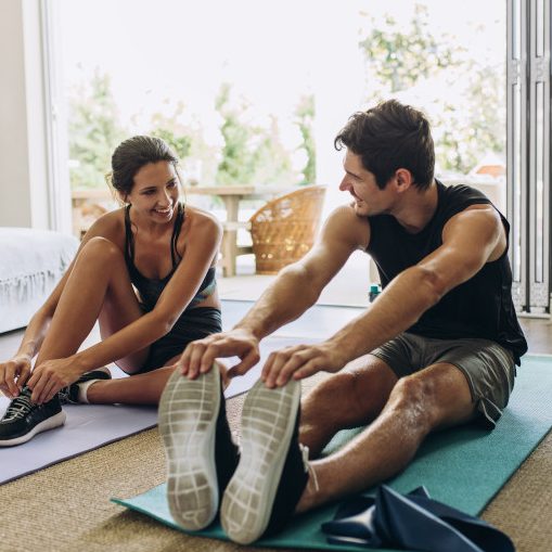 Couple exercising together. Man and woman in sports wear doing workout at home.; Shutterstock ID 1464709727; Purchase Order: Shutterstock_Portfolio Package_09102020; Job: ; Client/Licensee: Zurich Insurance Company Ltd; Other: 